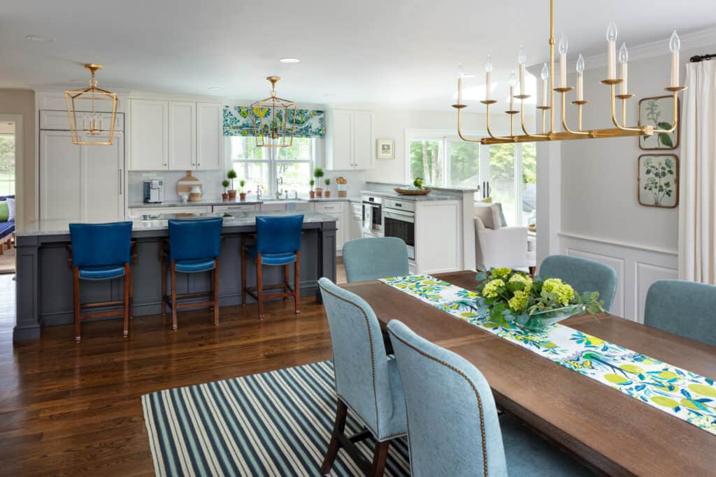 Brushed brass lighting fixtures bring warmth to this open concept Westborough Design Center kitchen.