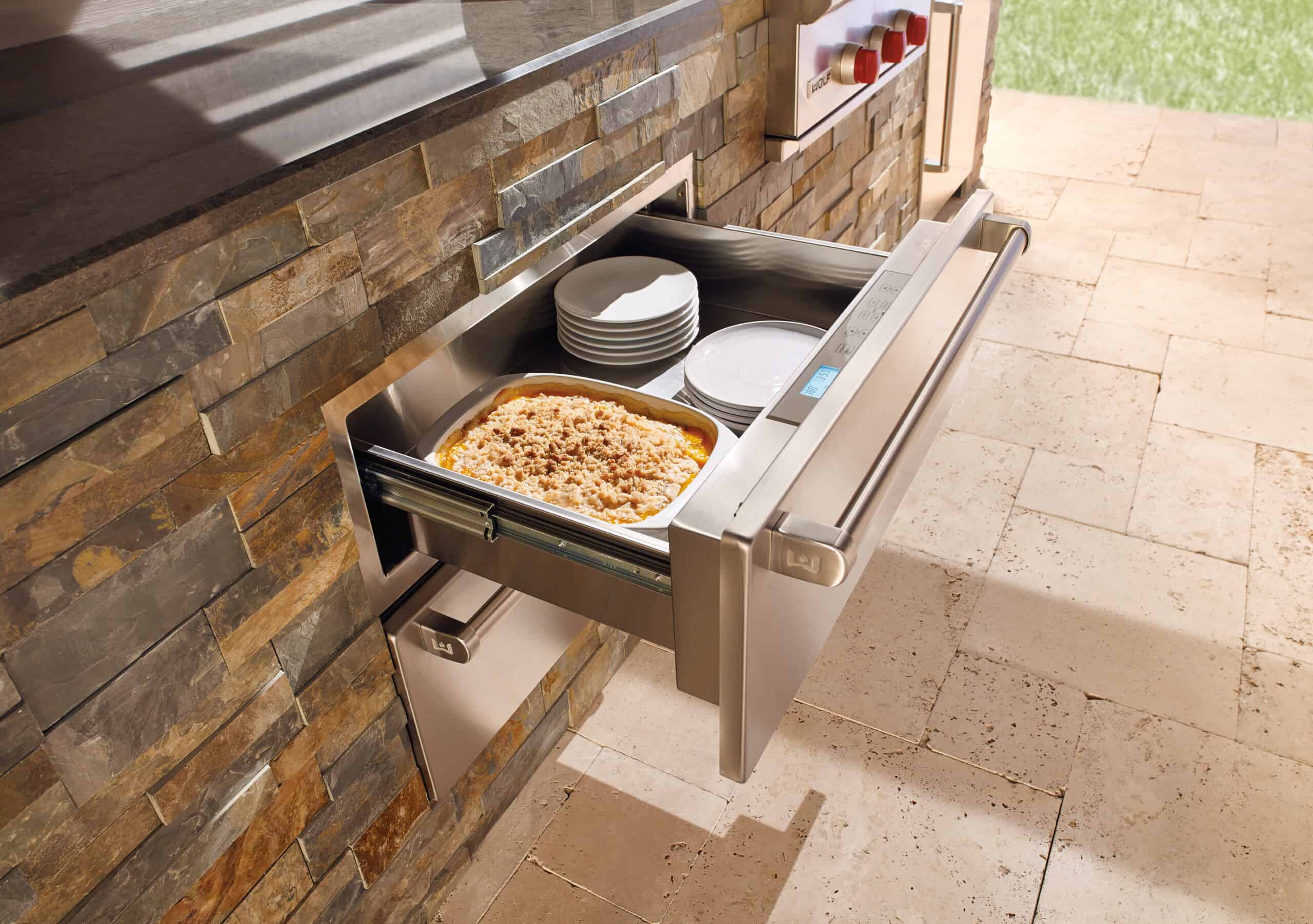 A Wolf Outdoor Warming Drawer can keep food warm, as well as plates or even towels by the pool!