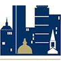 A simple graphic of a city skyline in blue and gold, featuring buildings, a dome, a church steeple, and hints of a luxury kitchen appliance showroom nestled among the architecture.