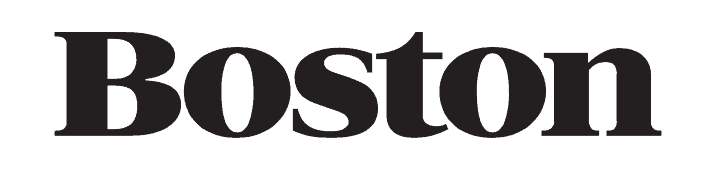 The word "Boston" is displayed in bold, black serif font on a white background, echoing the sleek signage found in a premium kitchen showroom featuring Sub Zero and Wolf appliances.