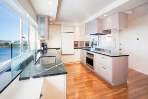 A Picture of the Clarke Winner's Kitchen Design. Kitchen has wood floors, black granite counter tops and white cabinets to resemble Mad Men 60's design style.