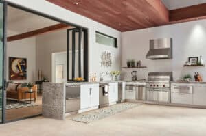 This Sub-Zero and Wolf Outdoor Dream Kitchen incorporates traditional cabinetry, Wolf stainless steel storage and stone countertops.