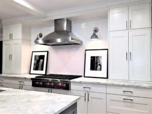 Black, white and a touch of Wolf red knobs makes this kitchen feel dressy, yet comfortable.