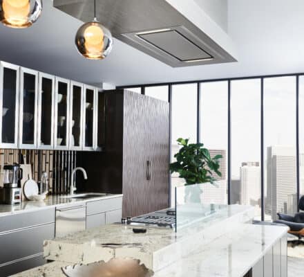 Modern kitchen with marble island countertop, luxury kitchen appliances, hanging pendant lights, a ventilation hood, and floor-to-ceiling windows showcasing city buildings in the background—perfect inspiration for any appliance showroom.