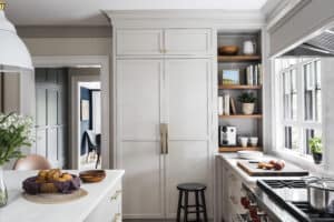 The integrated Sub-Zero refrigerator, with its millwork details and brass handles, presents as an armoire or closet in this kitchen, never betraying the home’s 1895 heritage, in this kitchen design celebrated at Clarke’s 2022 Designer Appreciation Night.