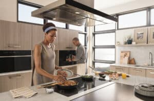Cleaning a A Wolf Induction Cooktop - A woman cooking