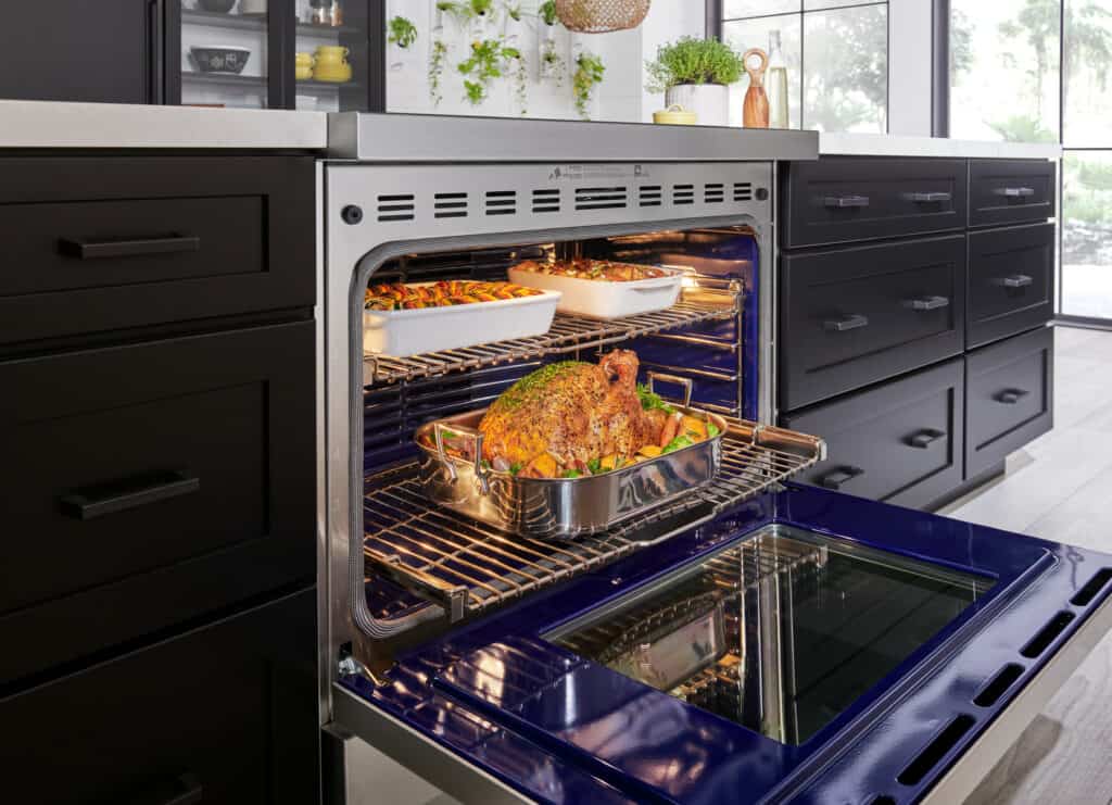 A food in an oven, expertly prepared with a Wolf appliance, showcases the innovation you’ll find in any modern kitchen showroom.