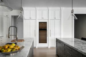 Sub-Zero refrigerator, freezer and wine storage present a dramatic wall in this transitional kitchen.