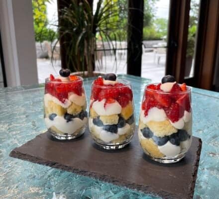 Refreshing Lemon Berry Trifle layered with lemon, fresh berries, and whipped cream, served in a glass dish, perfect for a light and fruity dessert