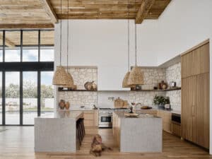 The gleaming stainless of the Wolf Gas Range in this modern home shows its style versatility.