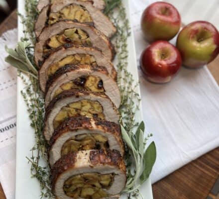Succulent Apple Sage Stuffed Pork Loin, sliced to reveal a flavorful filling of apples and fresh sage