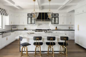 The Wolf Gas Range in this black, white and gold kitchen shows how the change of knob colors allows you to use Work appliances in any style home.