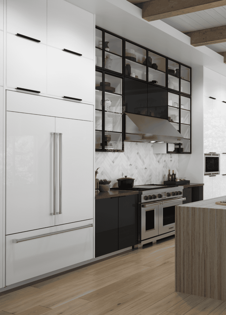 Modern kitchen with white cabinets, a built-in Sub Zero appliance refrigerator, black lower cabinets, open shelving, stainless steel Wolf appliance stove, and wood flooring. A light wood island is in the foreground.