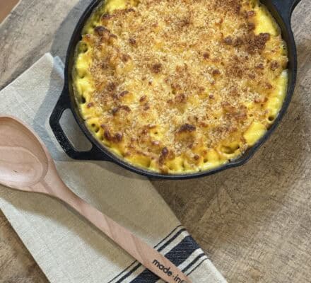 Rich and creamy Mac & Cheese in a baking dish, topped with a golden breadcrumb crust, perfect for a comforting and indulgent meal
